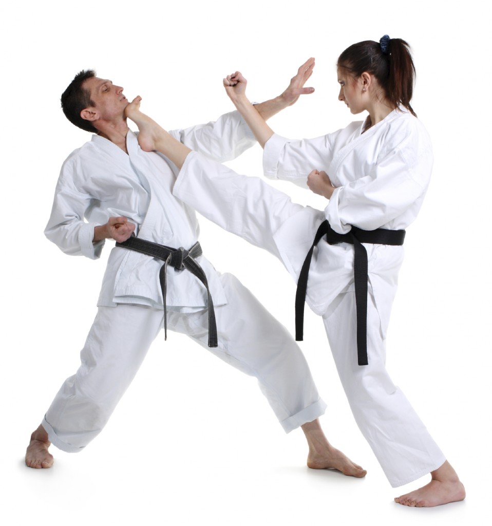 Karate. Young girl and a men in a kimono with a white background. Battle sports capture